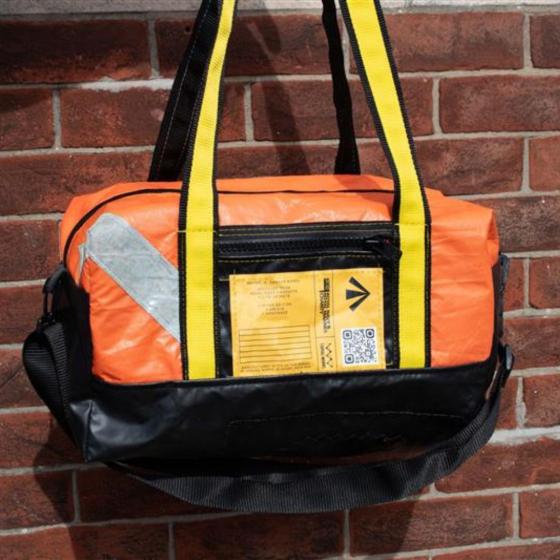 Front view, orange with life raft with "RNRMC X CANVAS WORKS" unique feature.