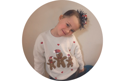 young girl with christmas jumper on