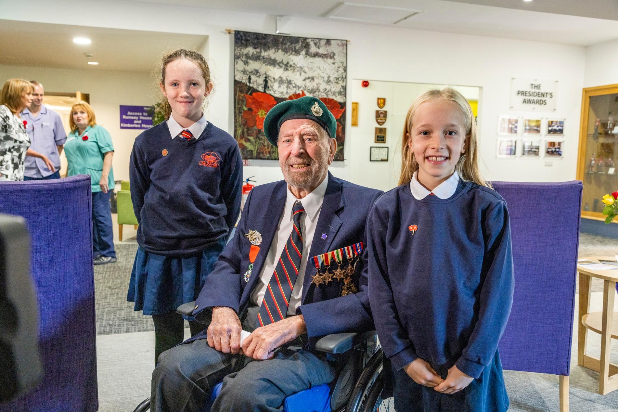 Sandy in uniform with 2 students