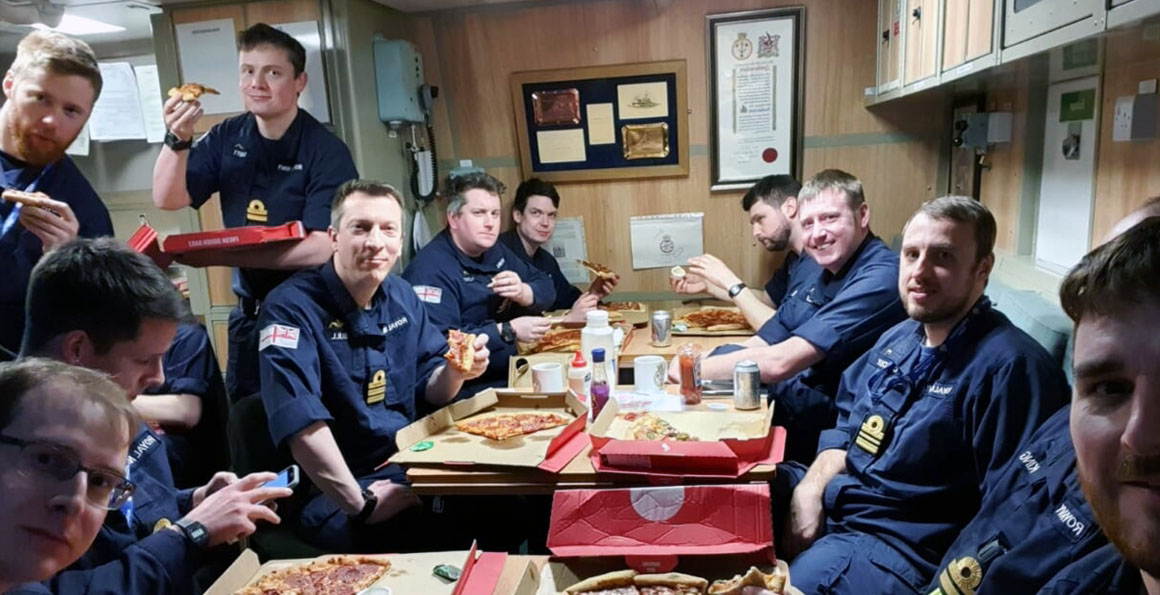 Submariners enjoy their meal on HMS Audacious 