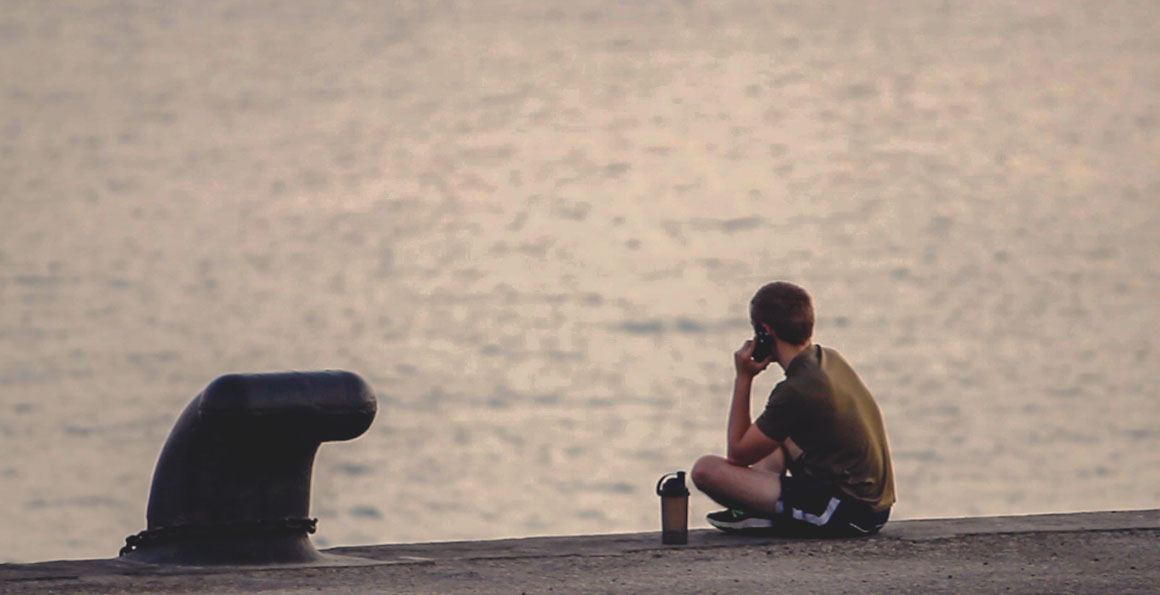 An HMS Montrose sailor calls home during quarantine alongside