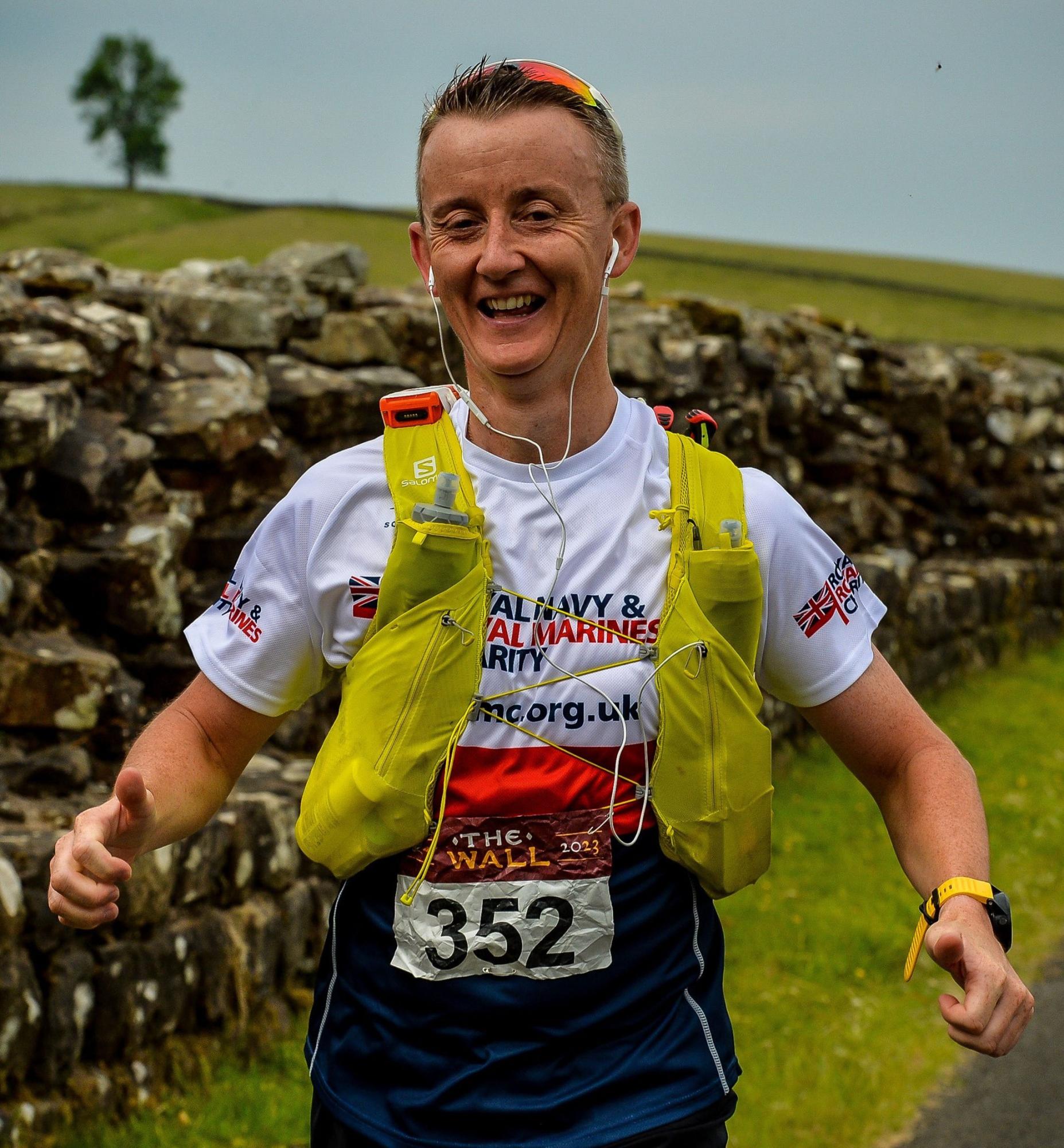 man running in an rnrmc vest 