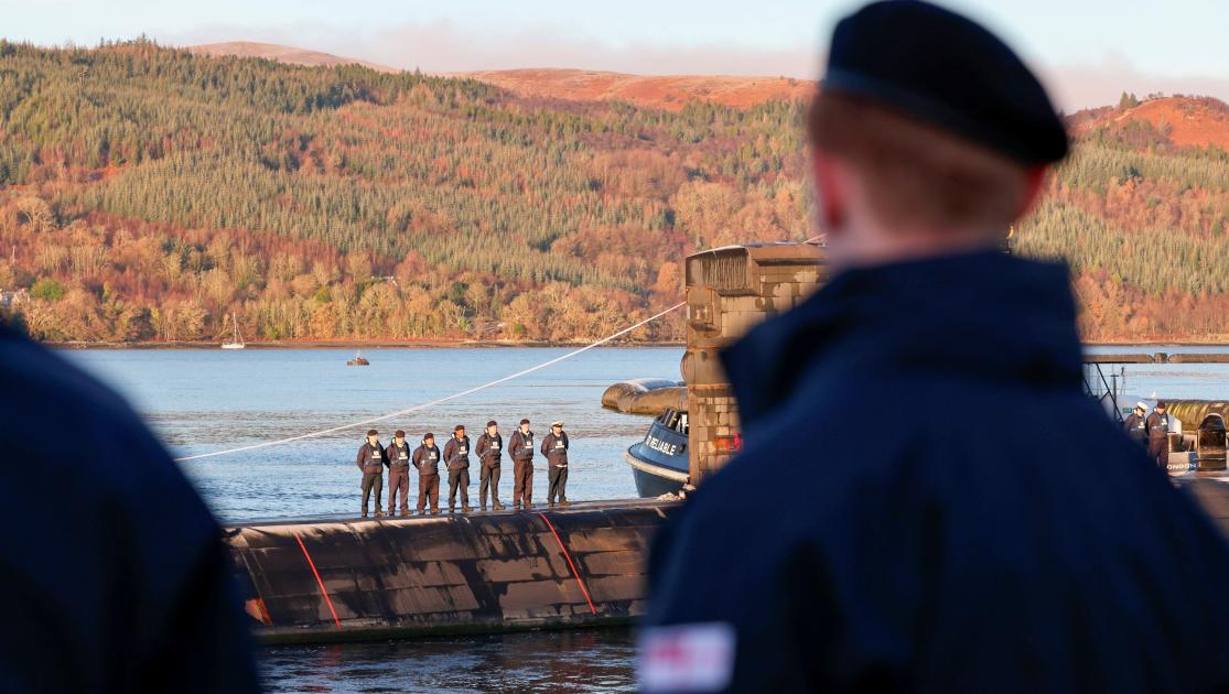 Submariner looking out to another submarine
