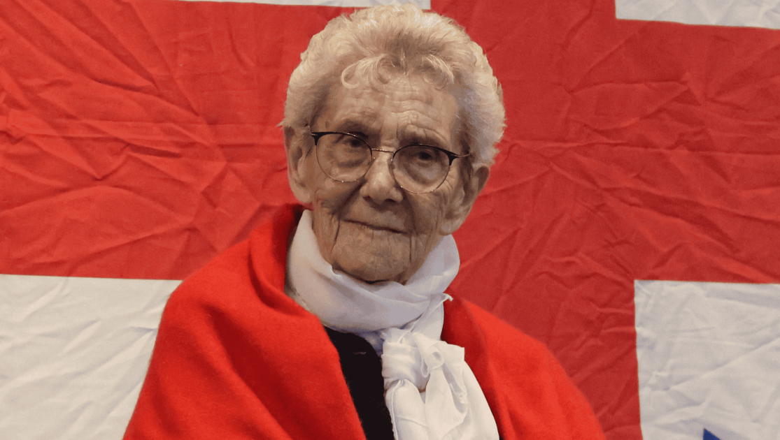 Lady looking directly into the camera smiling. 
