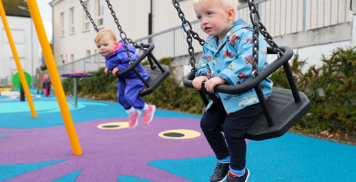 Children playing on swings at new Drumfork Children's Playpark