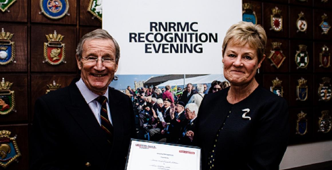 Retired Commander Jane Allen receiving an award for her Solo Round-Britain walk