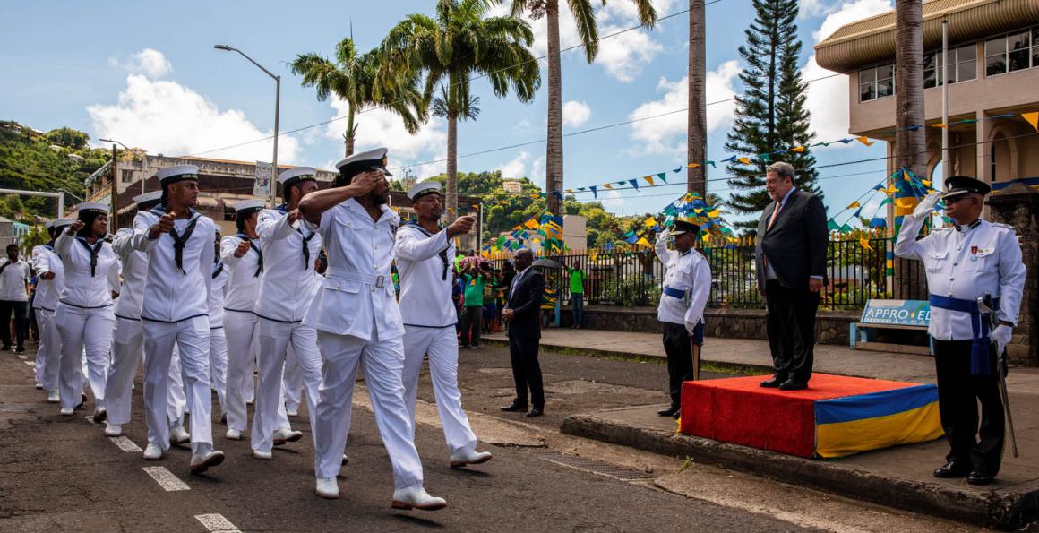 Royal Navy sailors parading past the prime minister Ralph Gonsalves