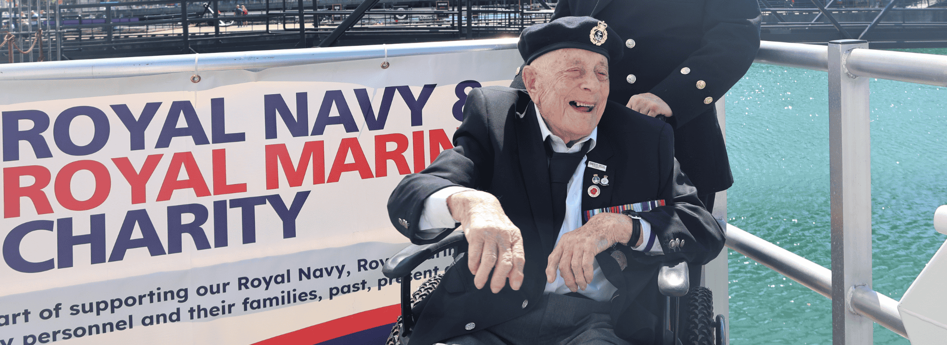 Veterans sat smiling with serving Navy.