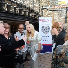 Poeple chatting onbaord the deck of the HMS Victory