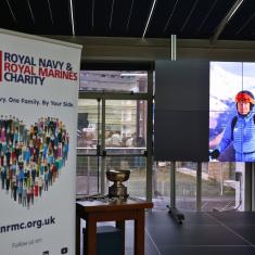 stage with screen showcasing winter games, plus a RNRMC banner in the foregroud