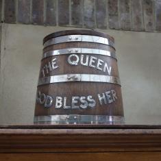 Small barrell with the words 'The Queen God Bless Her' in brass 