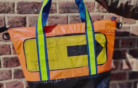 orange with yellow life raft feature, bright green and blue strap.