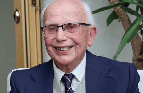 Man sat looking into camera, smiling