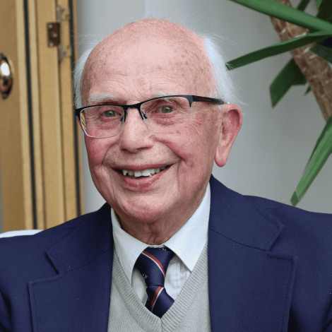Man sat looking into camera, smiling