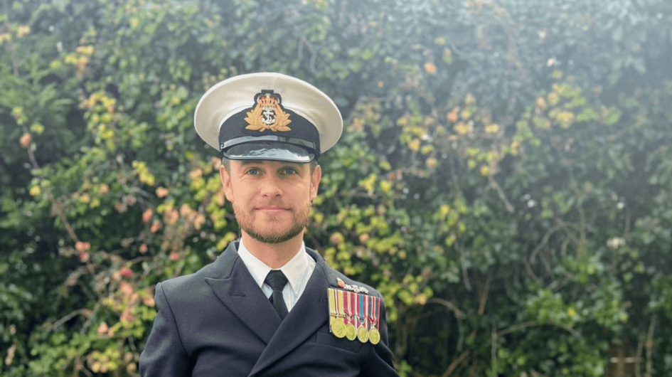 Man in Naval Uniform looking directly into the camera