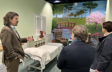 Man in care home describing the room with two ladies