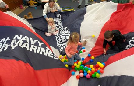 children playing with rnrmc parachute