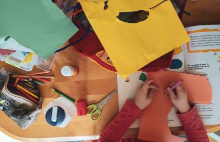 Child drawing and cutting paper